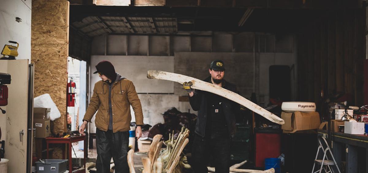 Representatives of Dinosaur Valley Studios move bones from a blue whale skeleton.