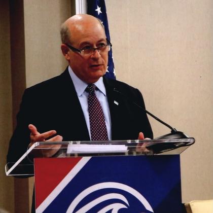 Rick Spinrad stands at a podium