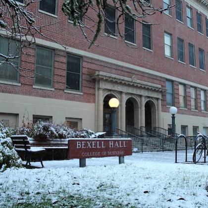 Stock image of Bexell Hall at OSU, blocky red brick building in the snow