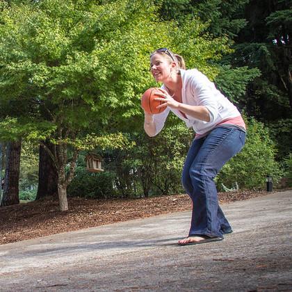 Parent holds a ball to pass to child