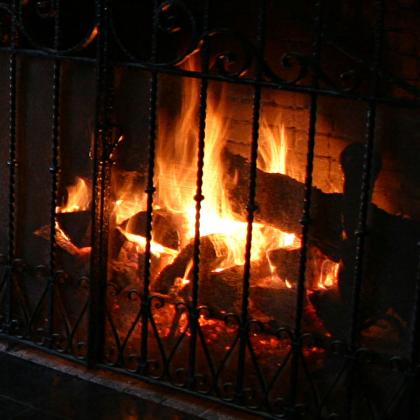 Wood burns in a fireplace.