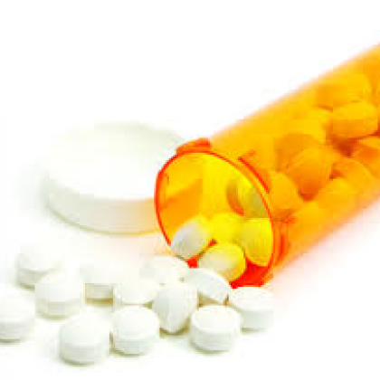 Stock photo of a prescription drug bottle with pills spilling out