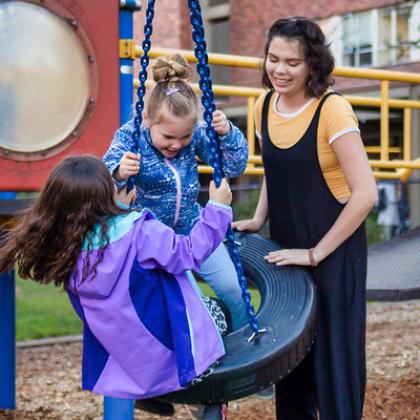 KidSpirit kids play on a tire swing