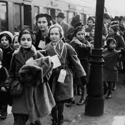 Black and white image of the "Kindertransport," with children gathered around a train
