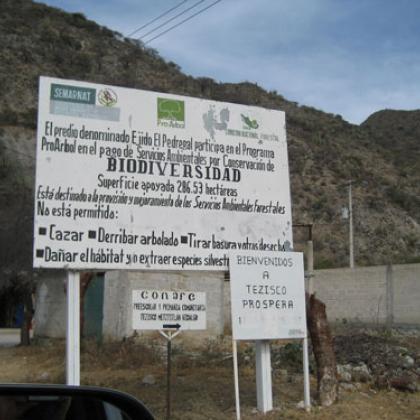 A sign tells visitors in Spanish that this community participates in Mexico’s Payments for Ecosystems Service Program for biodiversity conservation