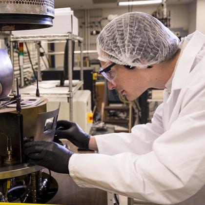 Carson Rivard, a doctoral student in electrical and computer engineering, is using a thermal evaporator in the Oregon State University cleanroom to deposit a thin film of aluminum. The cleanroom serves as a teaching laboratory as well as a research facili