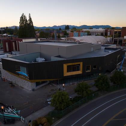 An aerial photo shows the large PRAx building under construction on OSU's campus.